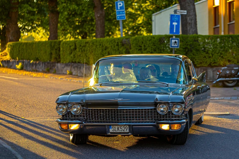 an old school car is driving down the street