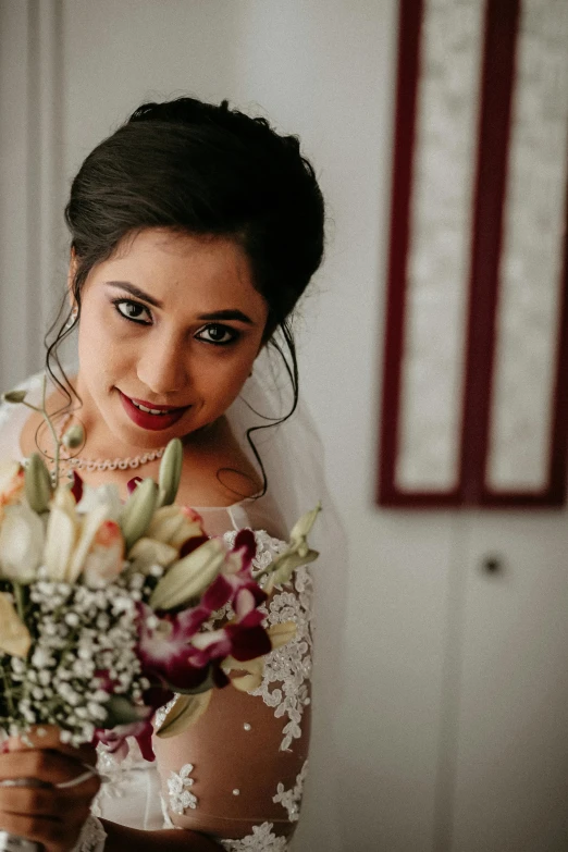 the bride is holding her bouquet of flowers