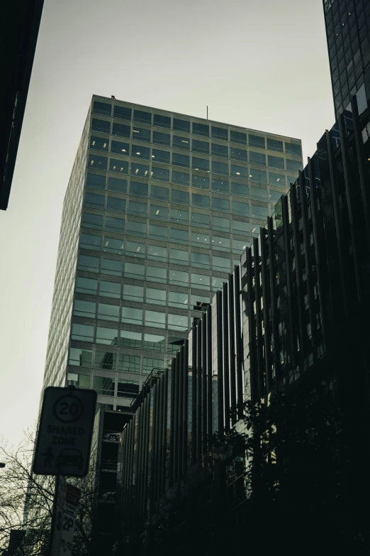 a tall building with lots of windows towering over another building