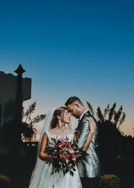 a young couple looking into each others eyes on their wedding day