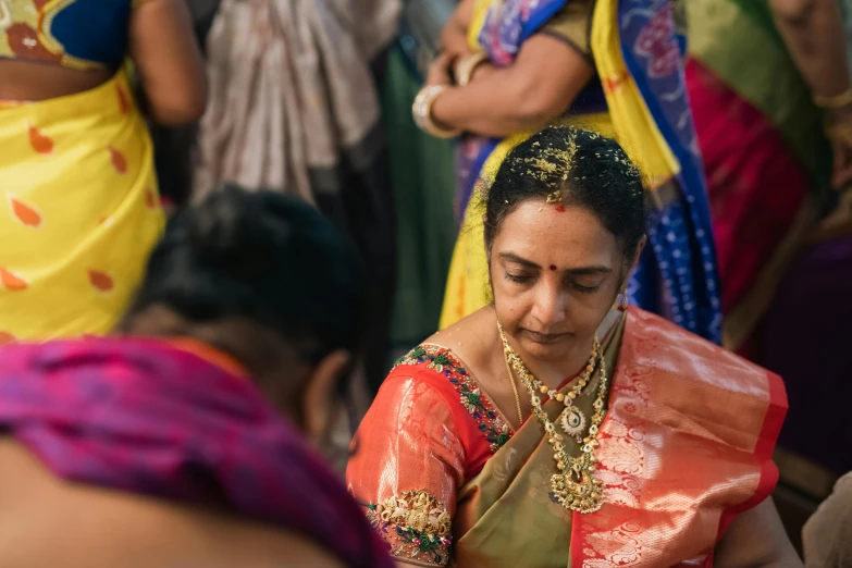 a woman in a sari is getting ready to perform