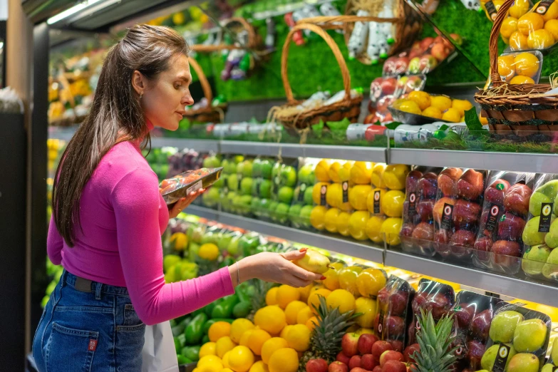 a young woman in a supermarket aisle browsing fruits and vegetables