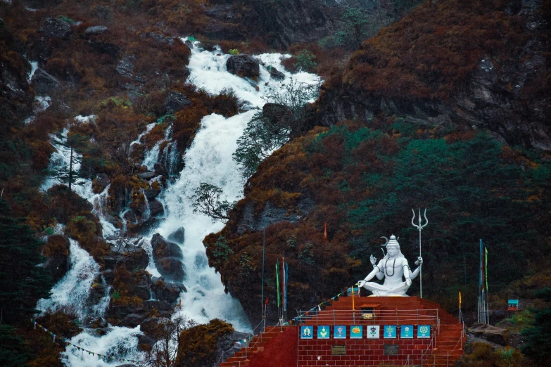 a large white buddha sitting on top of a wooden structure