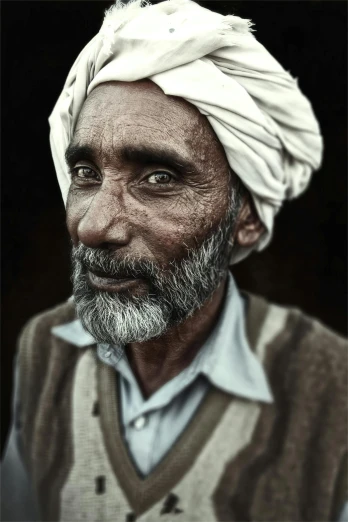 a man with a turban on his head in a po