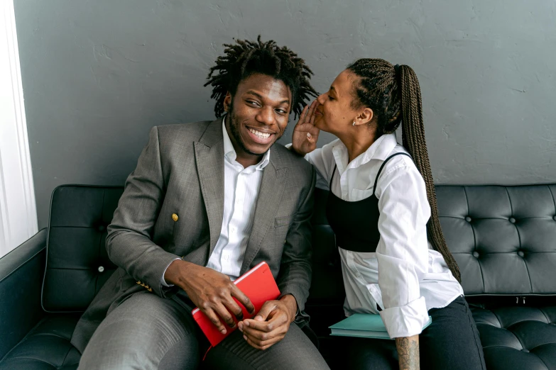 a woman talking to a man on a couch