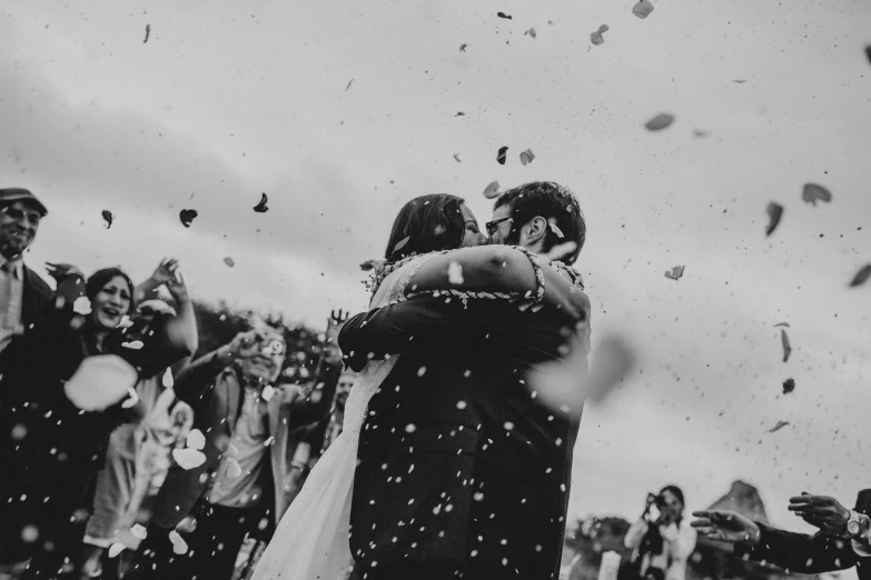 a group of people holding balloons are throwing confetti