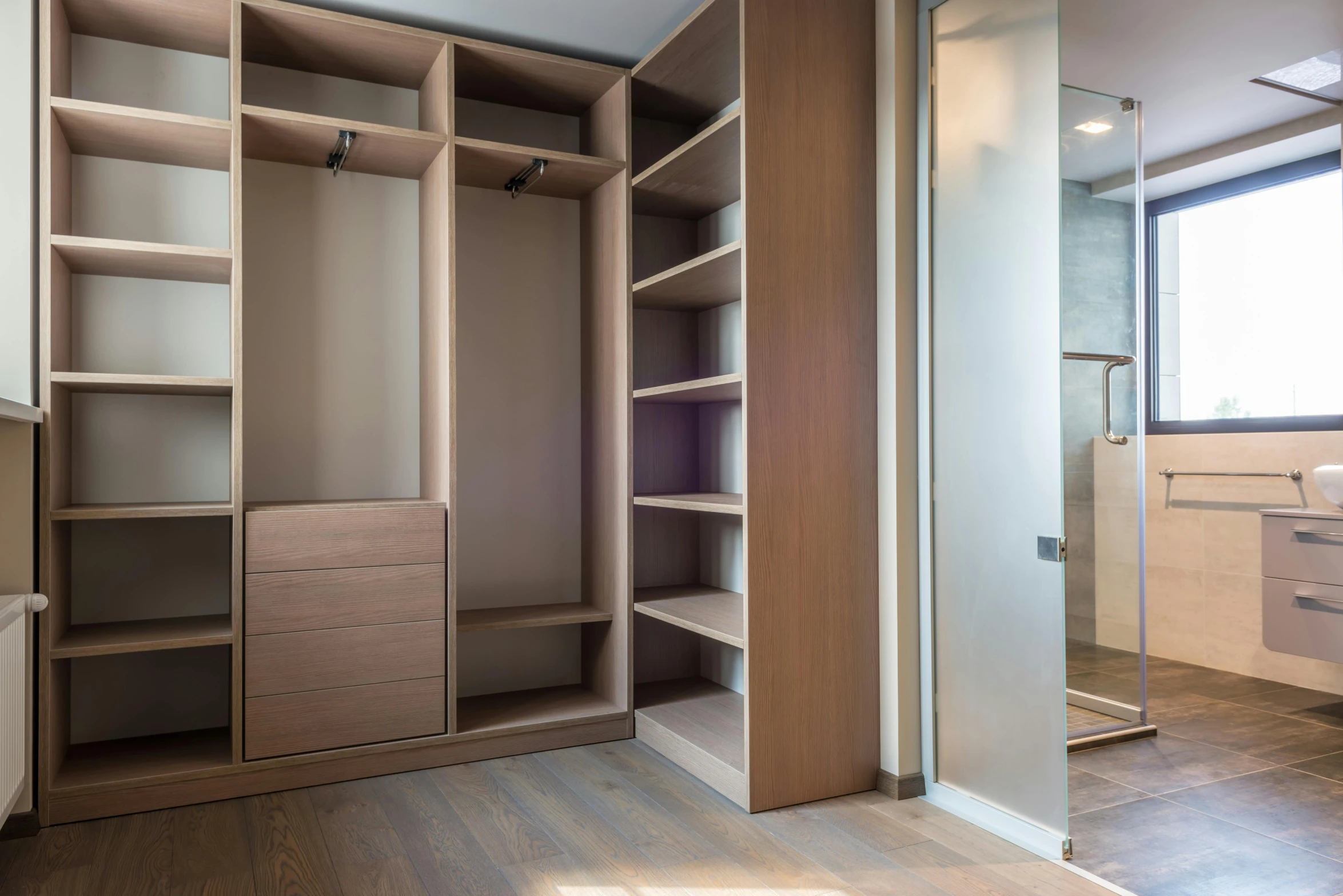 a walk in closet with a large mirror