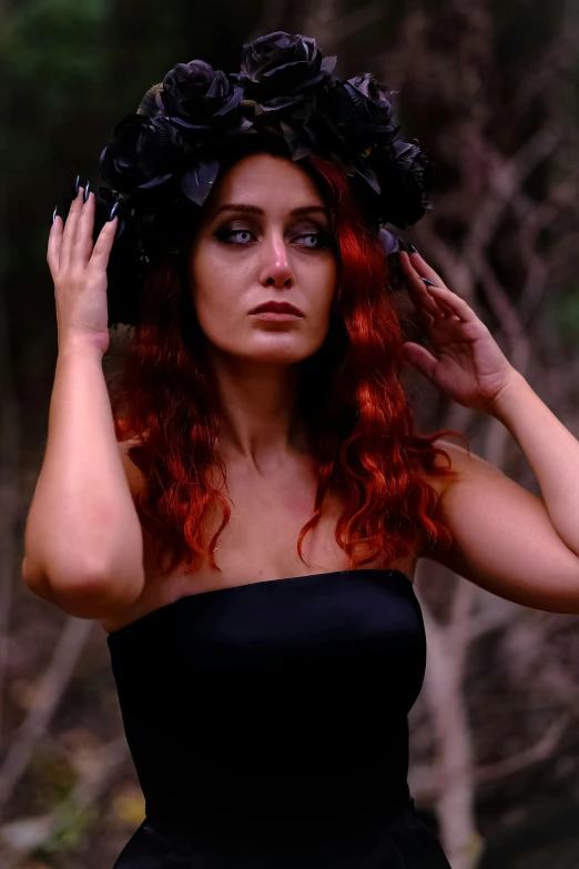 a woman in a black dress wearing a flower crown