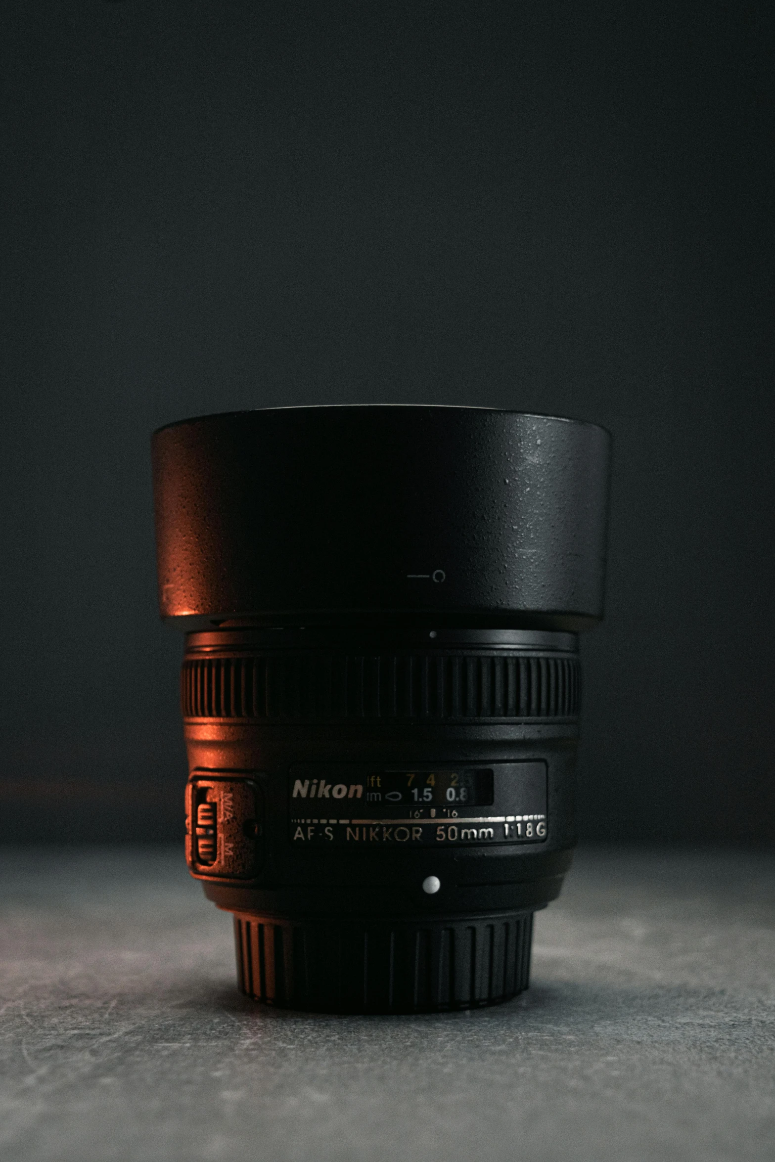 a lens sits on a countertop in the dark