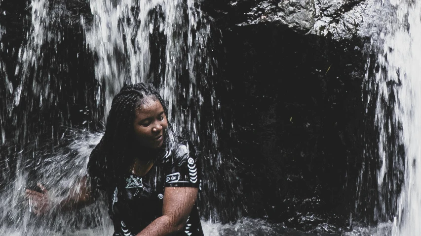 woman standing in front of waterfall in urban area