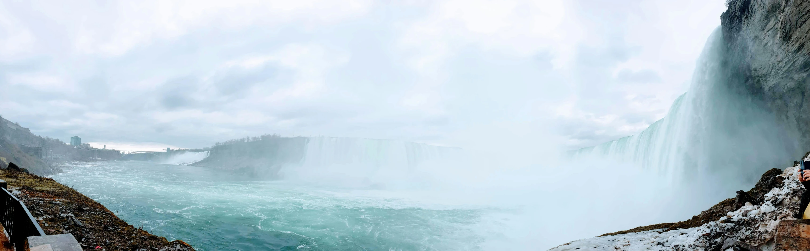 a person on top of the falls overlooking the water