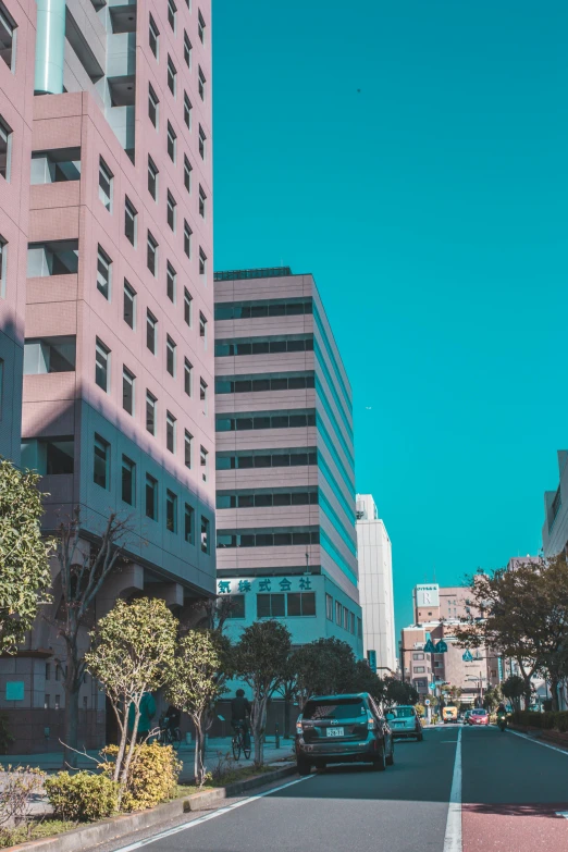 a city street lined with tall buildings and parked cars