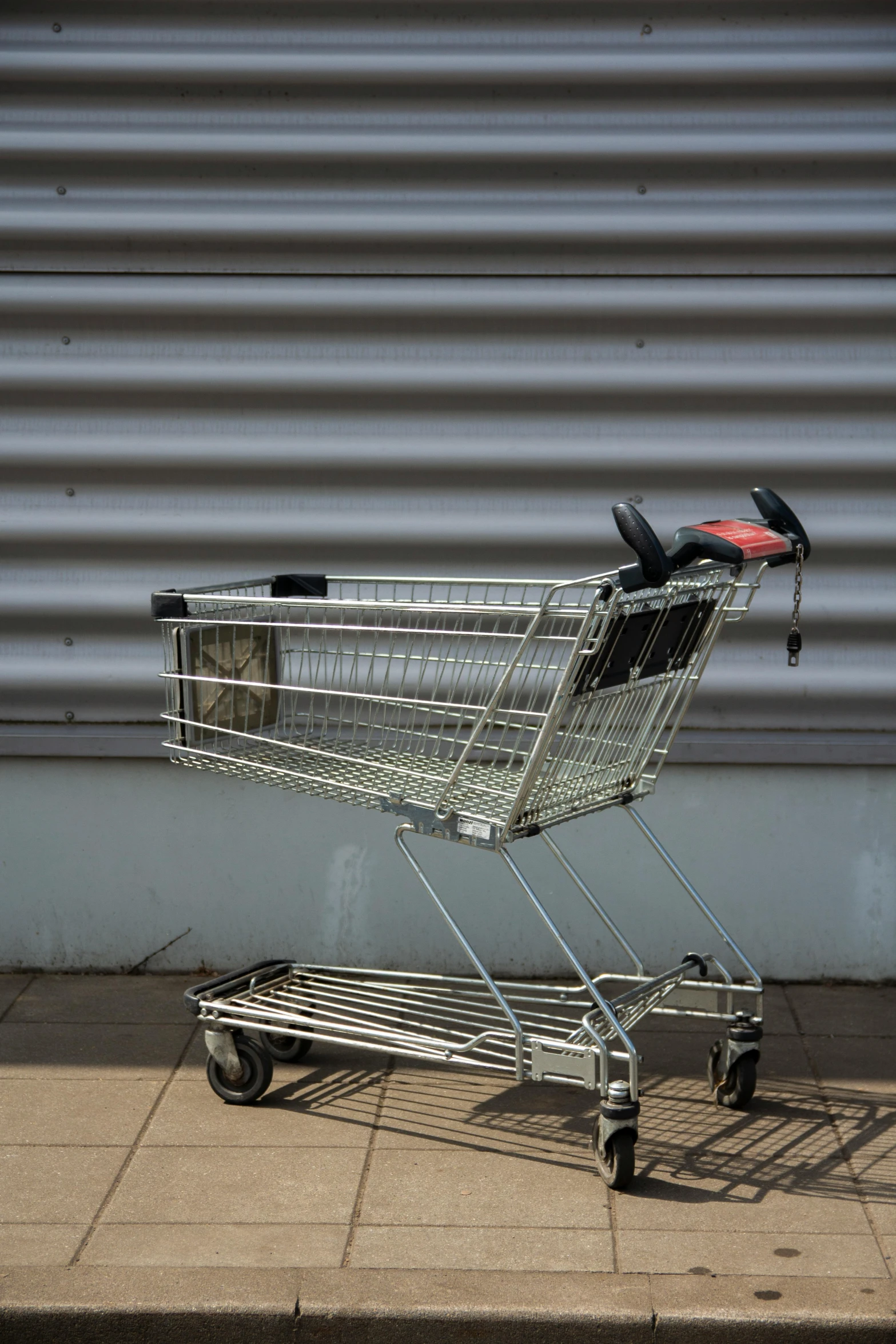 this shopping cart is empty and sitting outside