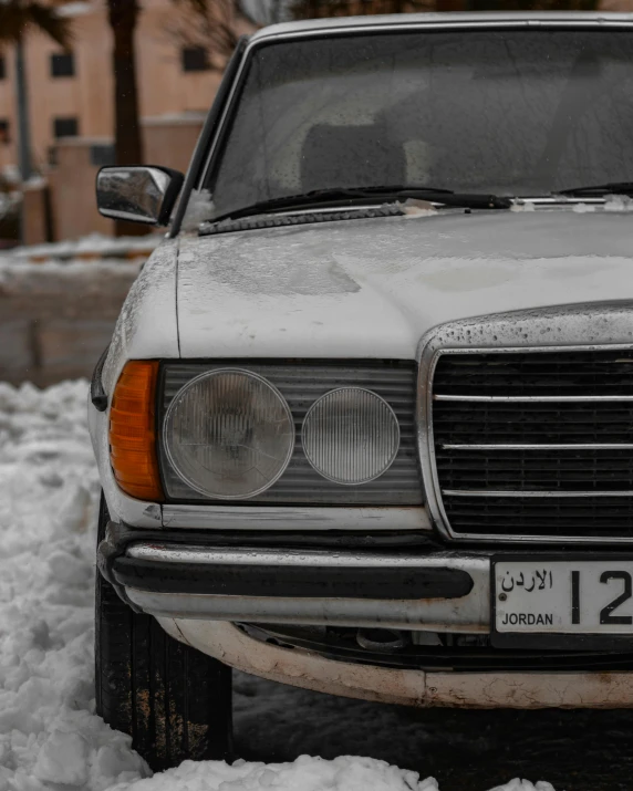 a car is partially covered in snow outside