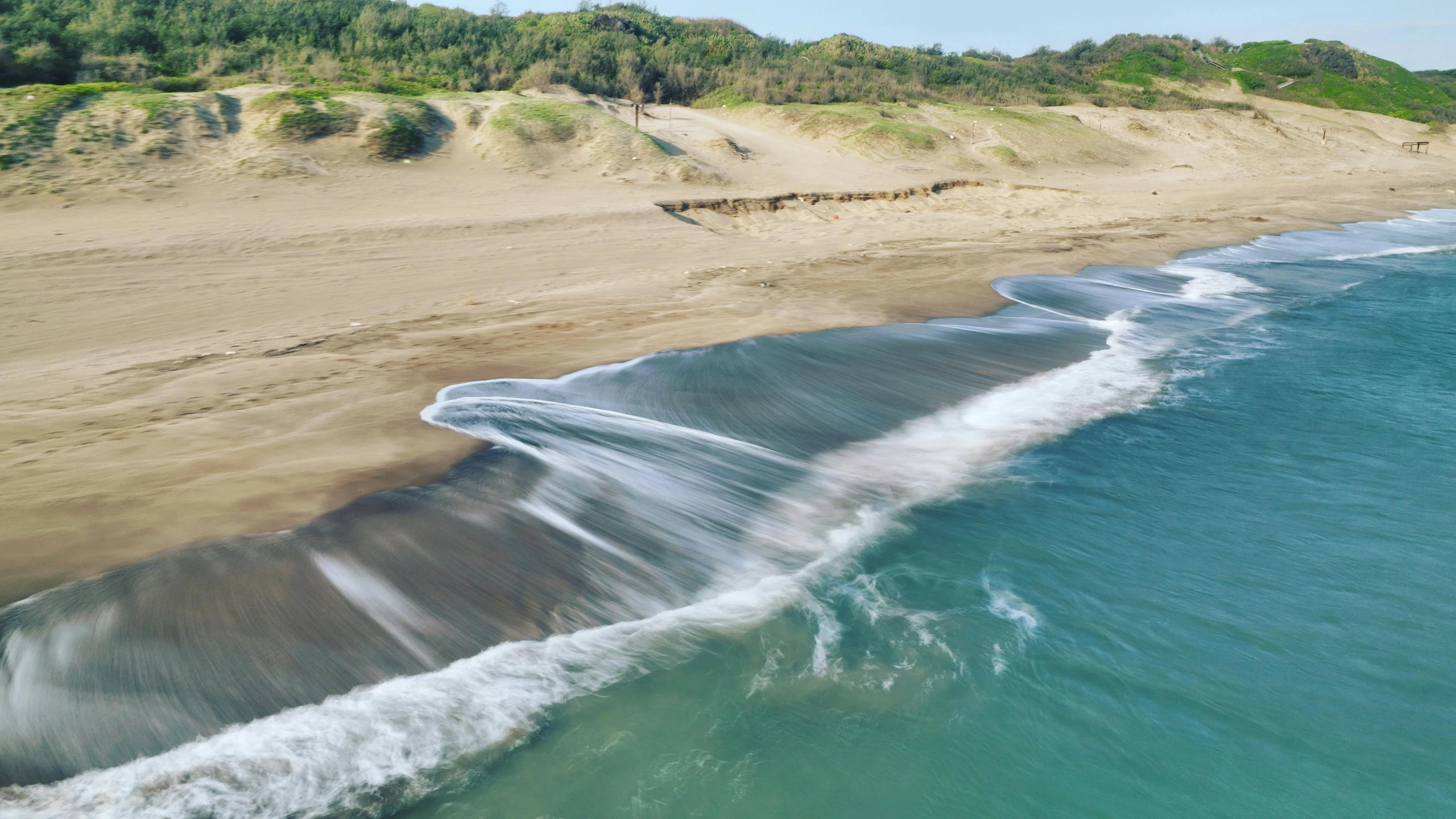 the beach has waves of water on it