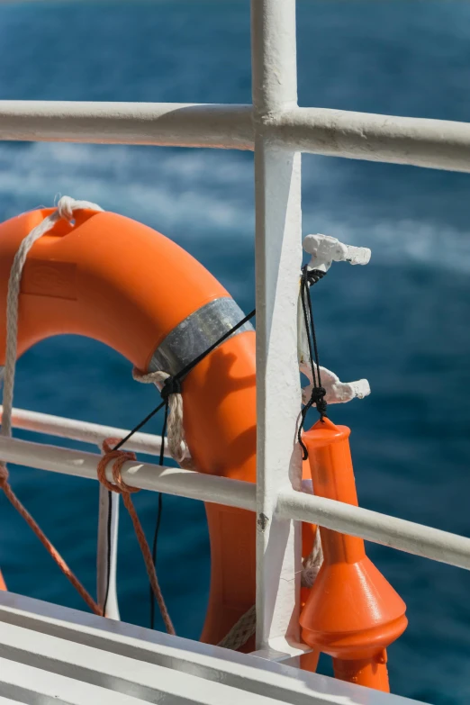 a large orange life saver on a ship in the ocean