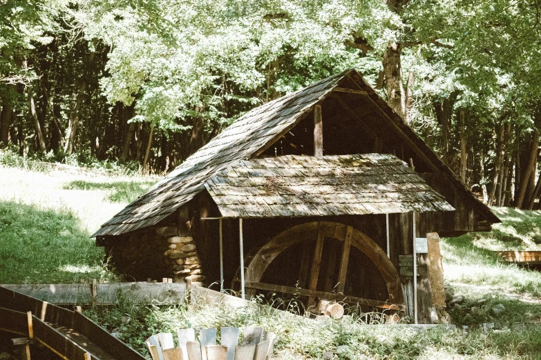 old fashioned shack on display with a tree in background