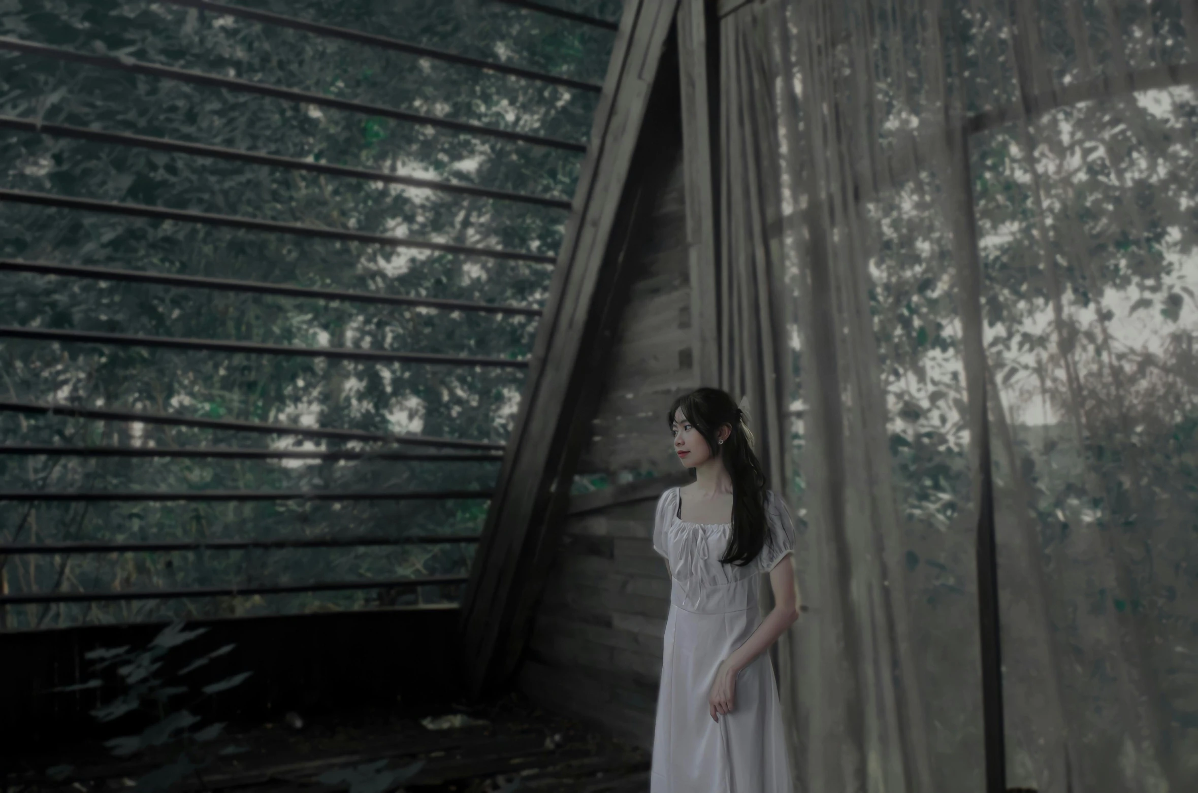 a woman standing next to a building in the forest