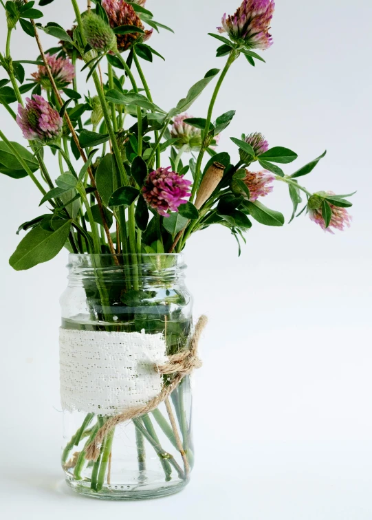 a clear jar with some pretty flowers inside