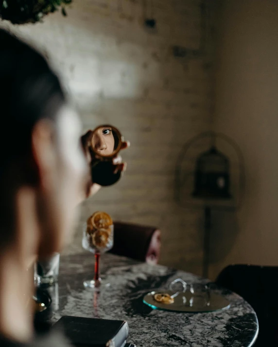 doll being pographed by person sitting at the table