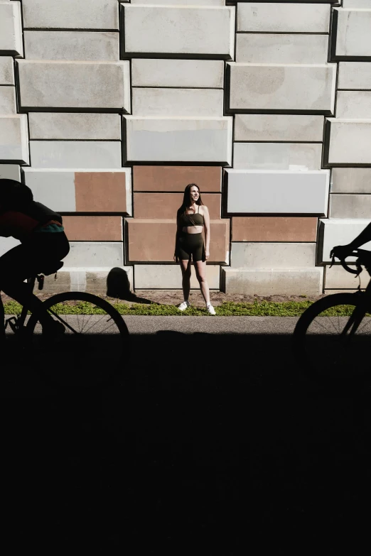 a person riding a bike in front of a building