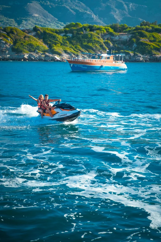 two people riding a boat in a blue body of water