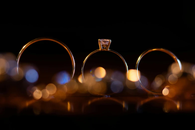 a pair of rings are seen near a candle light