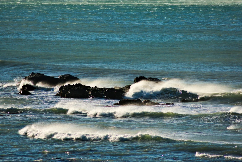 waves crashing over rocks in the ocean