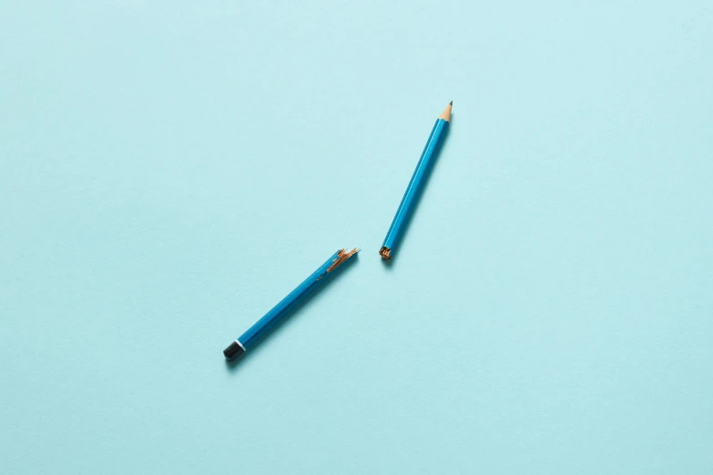 a pencil lying on a light blue background