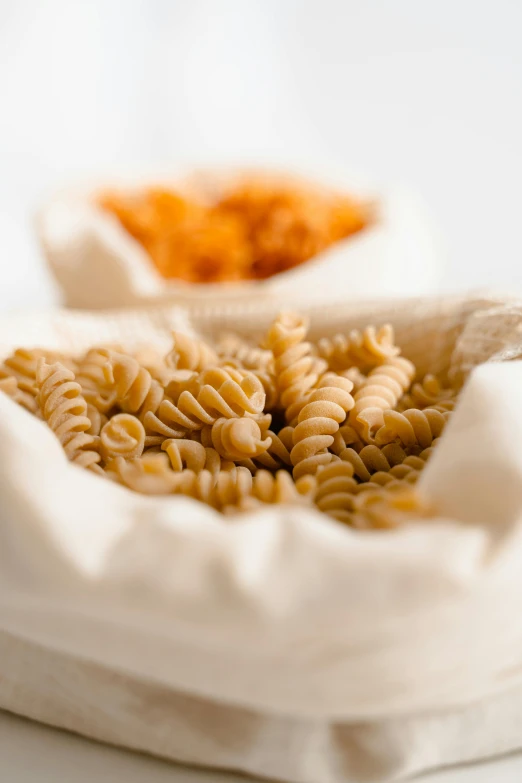 an assortment of pasta is sitting in a basket