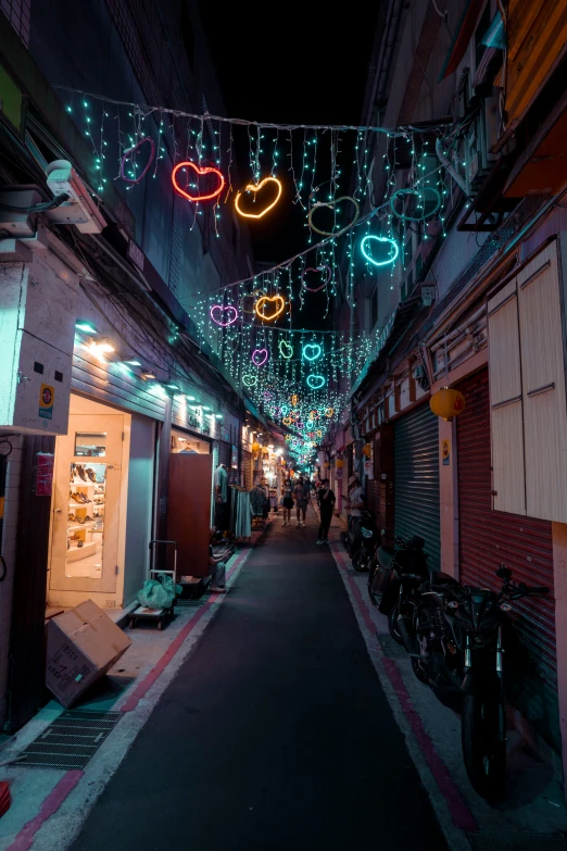 a street is decorated for christmas with many lights and ornaments