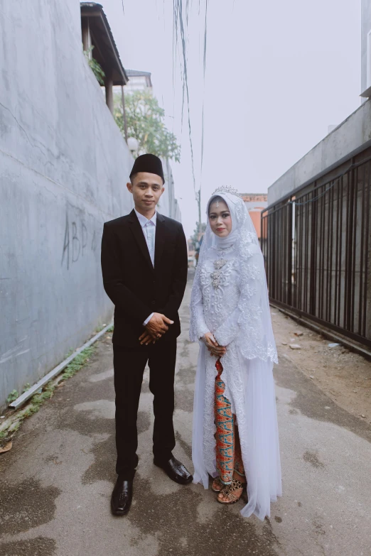 a young muslim couple posing for their wedding pictures