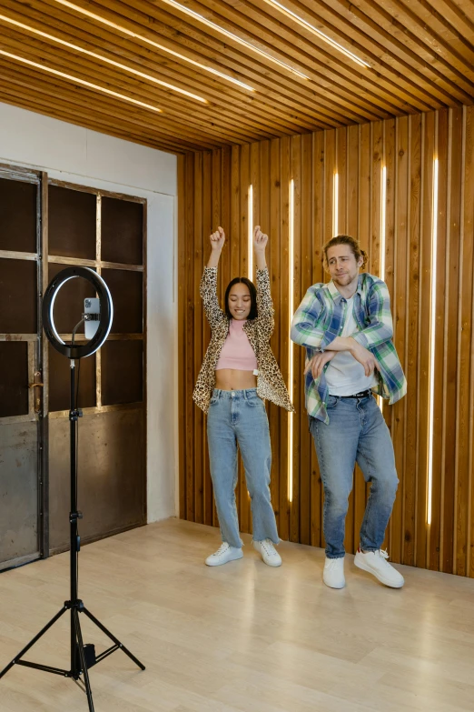 two people dance around in a large room