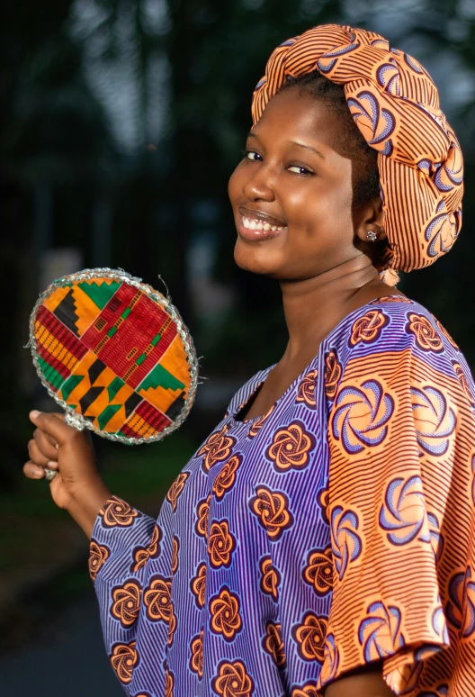 a woman holds a decorative item as she smiles