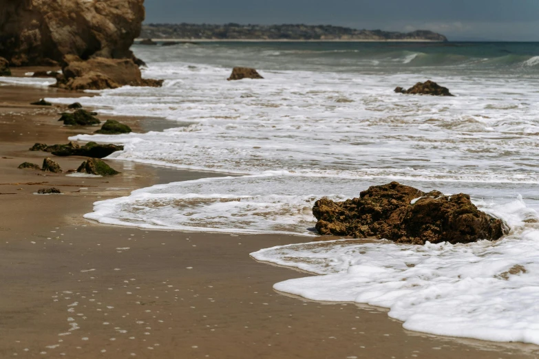 the ocean waves hit the shore at this beach