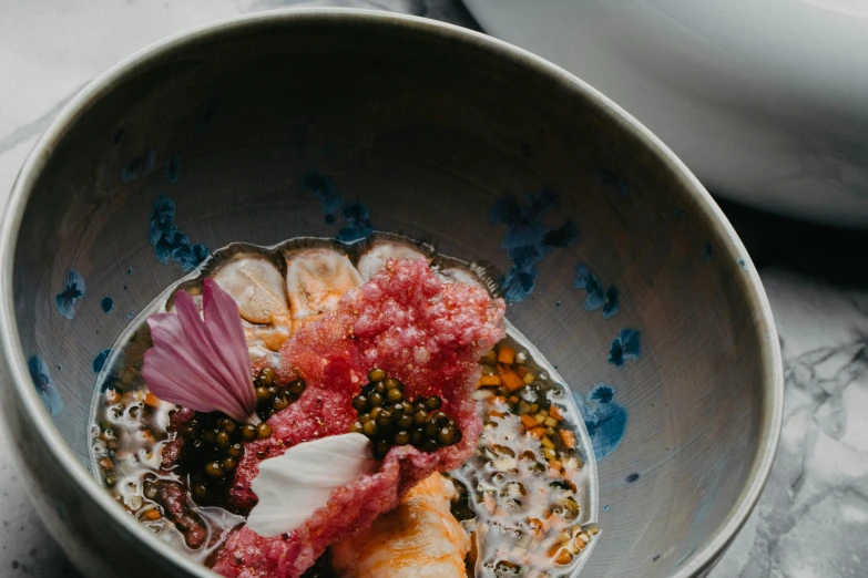 a bowl with food and seasoning on top of it