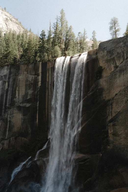 an image of a waterfall in the middle of the woods