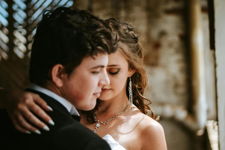 a woman in a white dress and a man with a black tie