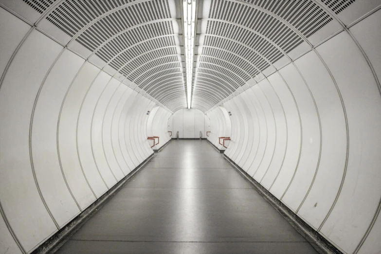 a walkway with a light in the middle between two white buildings