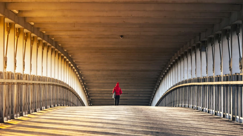 the person is walking over the pedestrian bridge