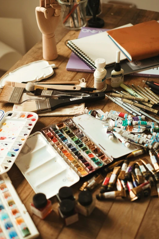 the table has a variety of arts supplies on it