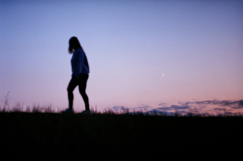 a blurry image of a person in the sky at sunset