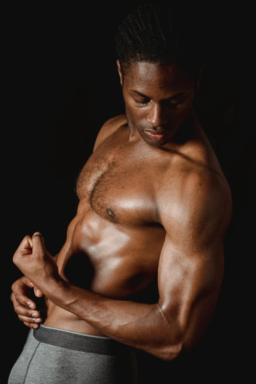 a bodybud man flexing his arms with his hand