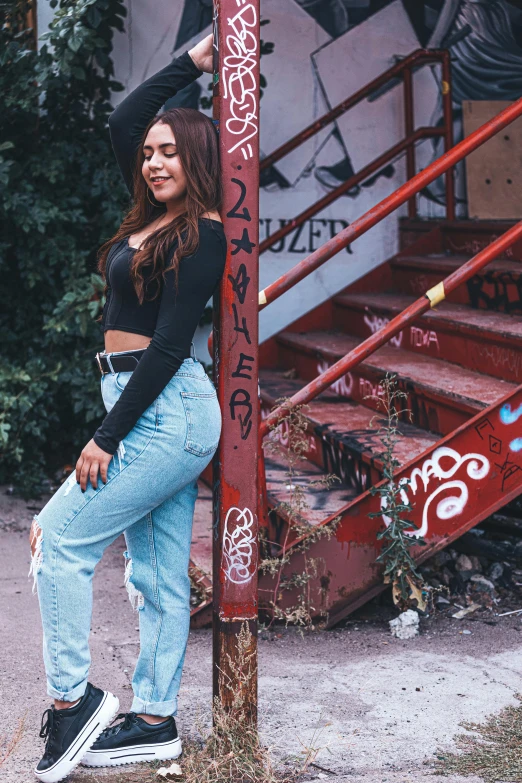 a woman is standing next to a red staircase