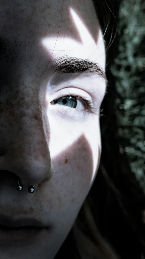 a woman has some piercings on her nose