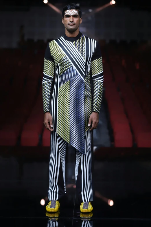 man on runway wearing all - black and white outfit