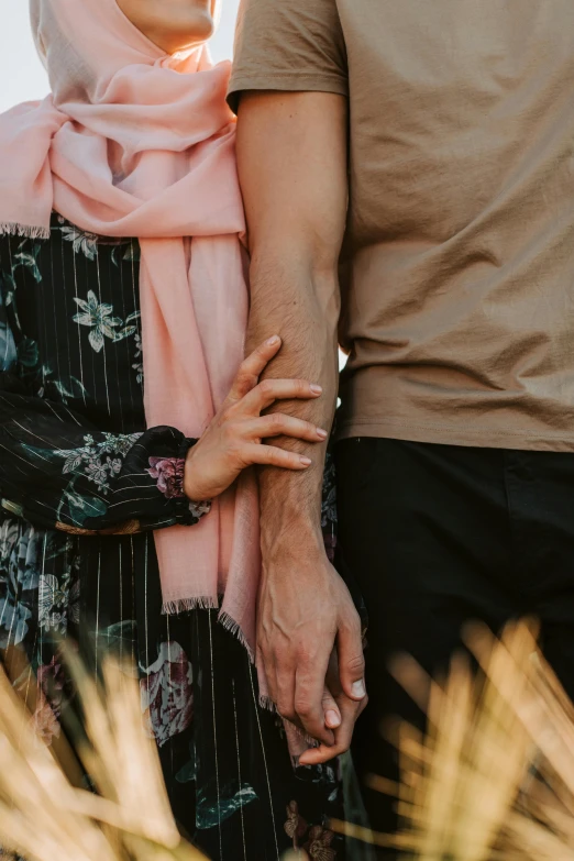 a young couple is holding hands in a desert