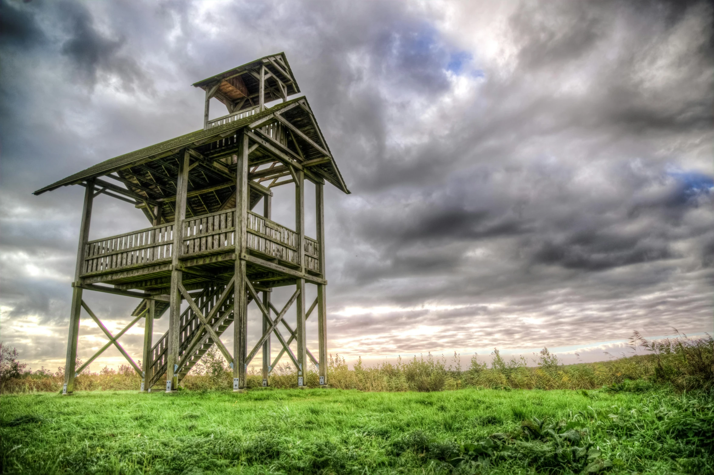 an observation tower sitting on top of a green field