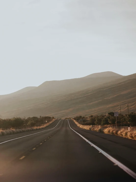 a long empty road leads into the mountains