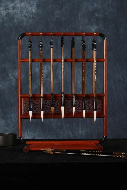 the wooden rack with lots of pool cues on it